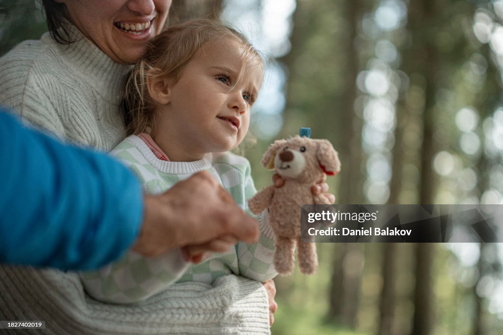 Parents with kid in the forest. POV, family camping. copy space