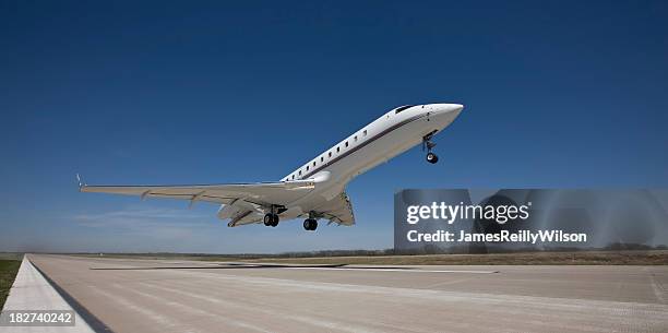 business jet rockets off the runway - corporate jet stock pictures, royalty-free photos & images