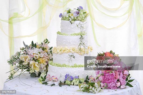 large wedding cake on table with flowers - wedding cake stock pictures, royalty-free photos & images