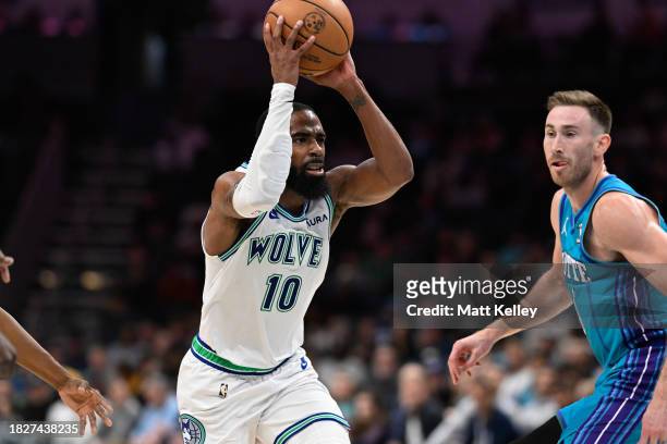 Mike Conley of the Minnesota Timberwolves looks to pass the ball during the second half of his game against the Charlotte Hornets at Spectrum Center...