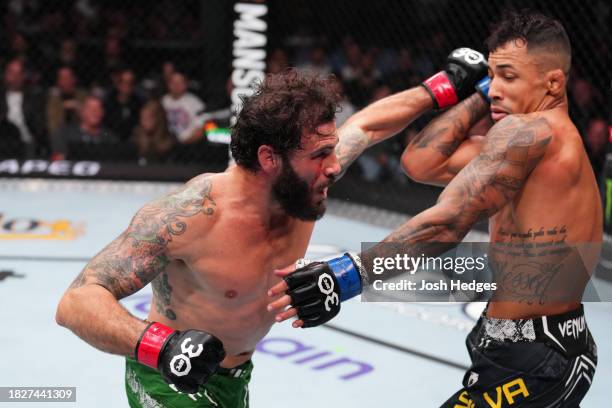 Clay Guida punches Joaquim Silva of Brazil in a lightweight fight during the UFC Fight Night event at Moody Center on December 02, 2023 in Austin,...