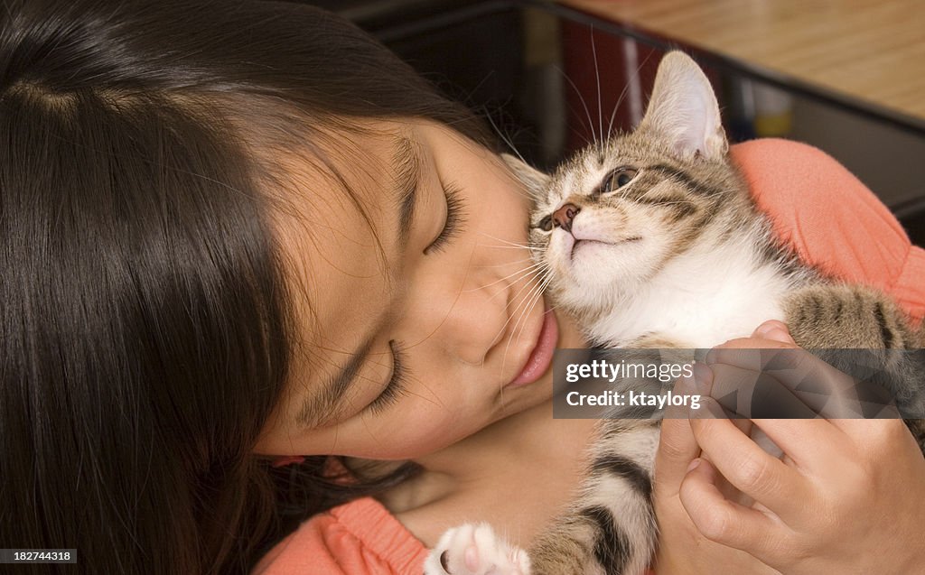 Girl caring for her kitten