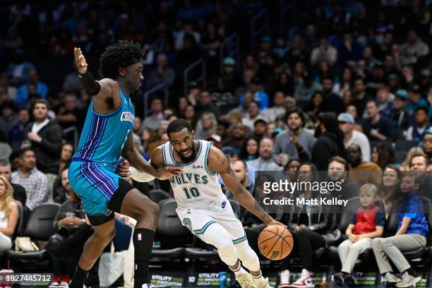 Mike Conley of the Minnesota Timberwolves drives past Mark Williams of the Charlotte Hornets during the second half of their game at Spectrum Center...