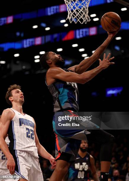 Mikal Bridges of the Brooklyn Nets heads for the net as Franz Wagner of the Orlando Magic defends during the first half at Barclays Center on...