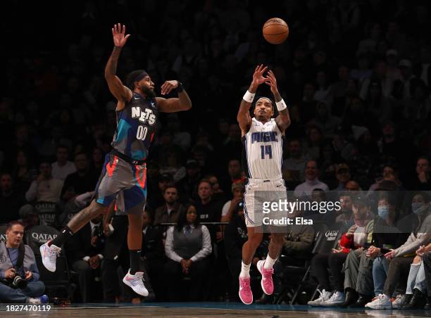 Royce O'Neale of the Brooklyn Nets and Gary Harris of the Orlando Magic go after the ball during the first half at Barclays Center on December 02,...