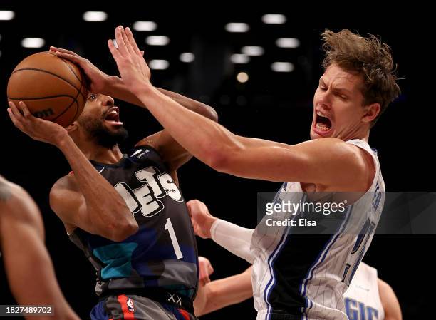 Mikal Bridges of the Brooklyn Nets heads for the net as Moritz Wagner of the Orlando Magic defends during the first half at Barclays Center on...