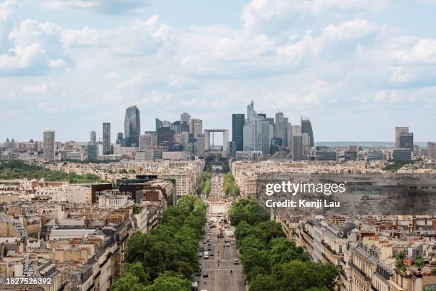 elevated view from arc de triomphe of the elegant street in paris leading to la defense under the clear blue summer sky. - arc de triomphe aerial view stock-fotos und bilder