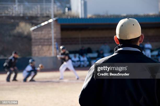 coaching the players - college baseball coach stock pictures, royalty-free photos & images