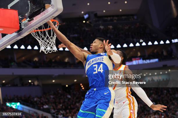 Giannis Antetokounmpo of the Milwaukee Bucks drives to the basket against Onyeka Okongwu of the Atlanta Hawks during the first half of a game at...