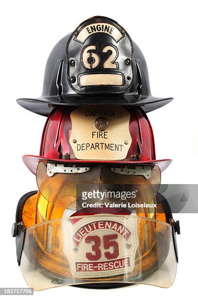drei feuerwehr-helme - firefighter's helmet stock-fotos und bilder