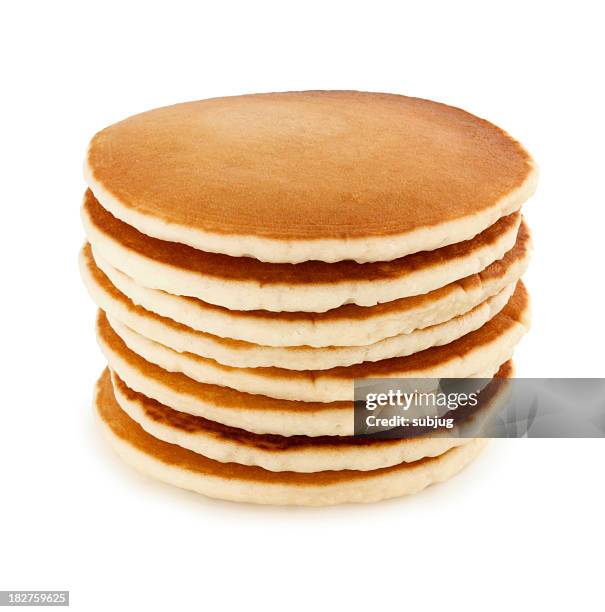 stack of eight buttermilk pancakes on a white table - pannenkoek stockfoto's en -beelden