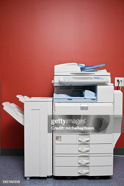 large office photocopier in front of red wall - copier stock pictures, royalty-free photos & images