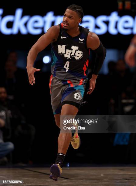 Dennis Smith Jr. #4 of the Brooklyn Nets celebrates his dunk during the second half against the Orlando Magic at Barclays Center on December 02, 2023...