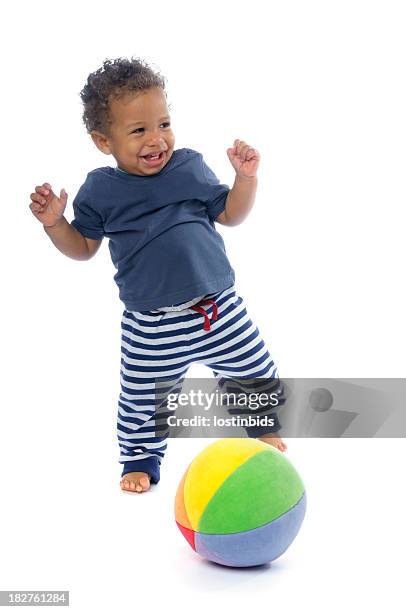 happy baby smiling while playing football - kicking ball stock pictures, royalty-free photos & images