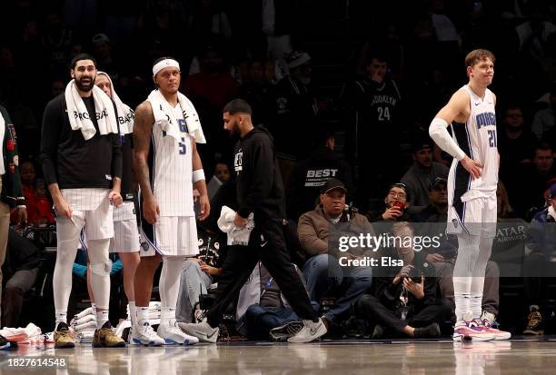 Goga Bitadze,Paolo Banchero and Moritz Wagner of the Orlando Magic react to the loss to the Brooklyn Nets at Barclays Center on December 02, 2023 in...