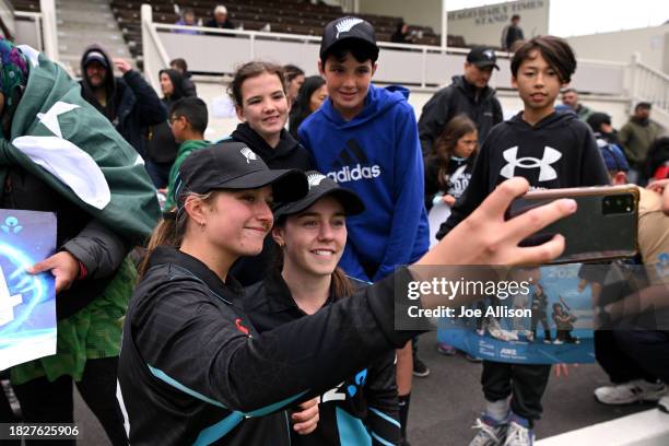 Izzy Gaze and Fran Jonas of New Zealand take a photo with fans during game one of the Women's T20 International series between New Zealand and...