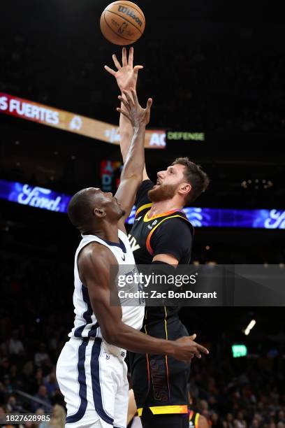 Jusuf Nurkic of the Phoenix Suns shoots a basket against Bismack Biyombo of the Memphis Grizzlies during the second quarter at Footprint Center on...