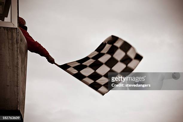 man on tower waving checkered flag - grand prix motor racing stock pictures, royalty-free photos & images