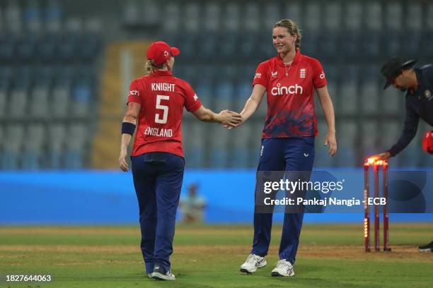Heather Knight captain of England and Lauren Bell of England tcelebrate their team's win over India during the 1st T20 International match between...