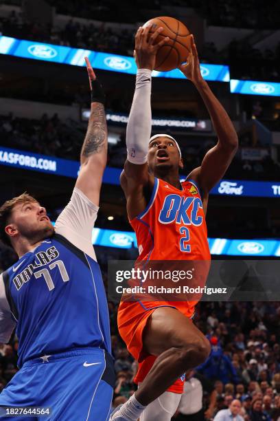 Luka Doncic of the Dallas Mavericks defends a shot by Shai Gilgeous-Alexander of the Oklahoma City Thunder in the first half at American Airlines...