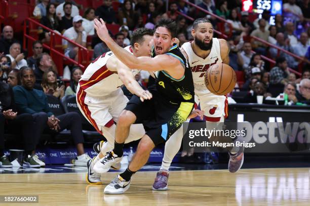 McConnell of the Indiana Pacers drives against Duncan Robinson and Caleb Martin of the Miami Heat during the fourth quarter of the game at Kaseya...