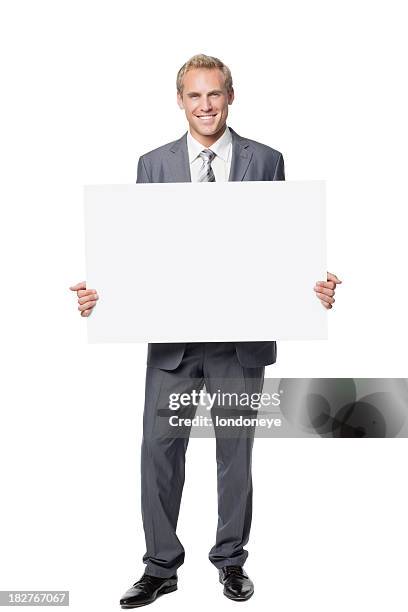 atractivo hombre de negocios sosteniendo un cartel en blanco - person holding blank sign fotografías e imágenes de stock