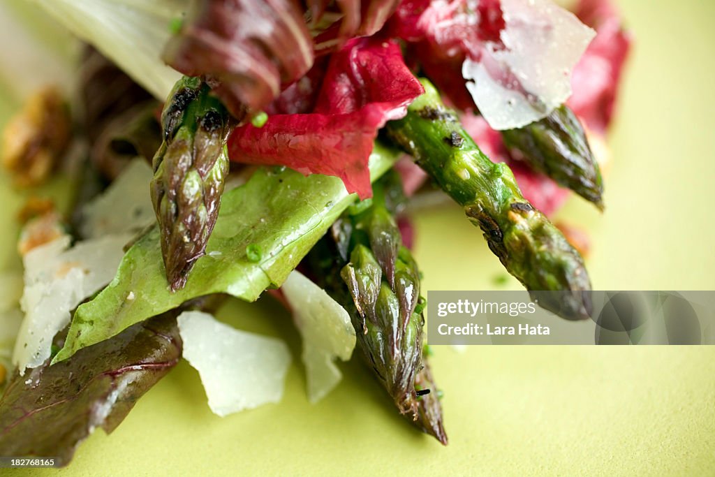 Close-up of asparagus salad on green plate