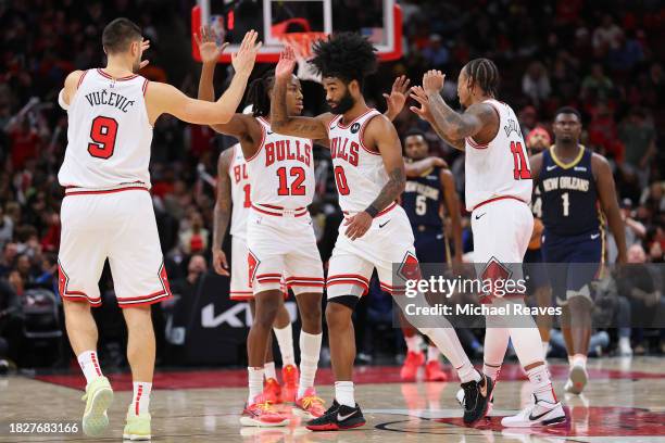 Coby White of the Chicago Bulls celebrates a three pointer with teammates against the New Orleans Pelicans during the second half at the United...