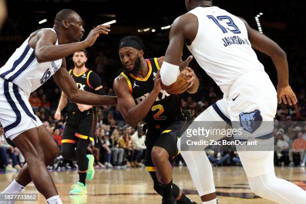 Josh Okogie of the Phoenix Suns drives to the net against Bismack Biyombo of the Memphis Grizzlies and Jaren Jackson Jr. #13 during the first quarter...