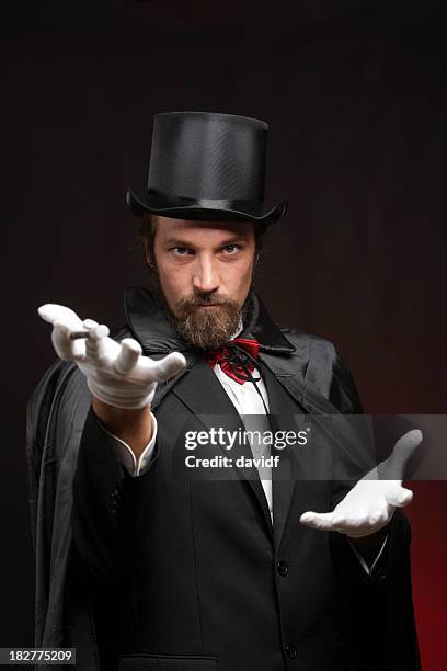 magician performing tricks - goochelaar stockfoto's en -beelden