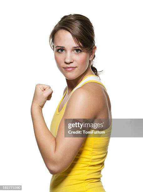 young fit woman showing off her muscle - woman arm fist stock pictures, royalty-free photos & images