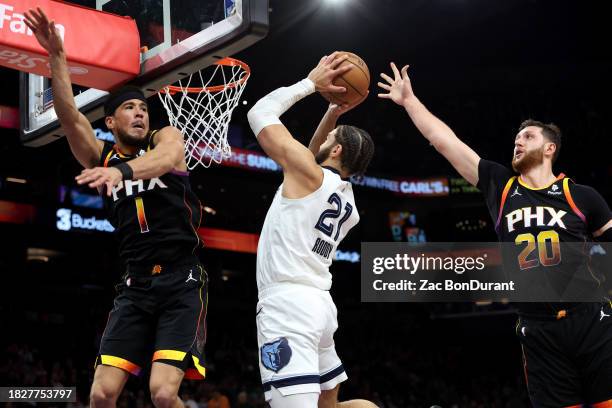 David Roddy of the Memphis Grizzlies shoots a basket against Devin Booker of the Phoenix Suns and Jusuf Nurkic during the third quarter at Footprint...