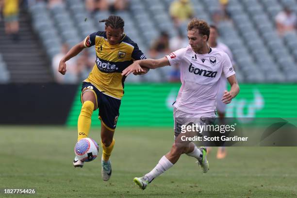William Wilson of the Mariners competes for the ball with Franco Lino of Melbourne Victory during the A-League Men round six match between Central...
