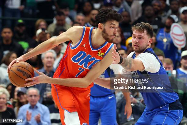 Chet Holmgren of the Oklahoma City Thunder is guarded by Luka Doncic of the Dallas Mavericks in the fourth quarter at American Airlines Center on...