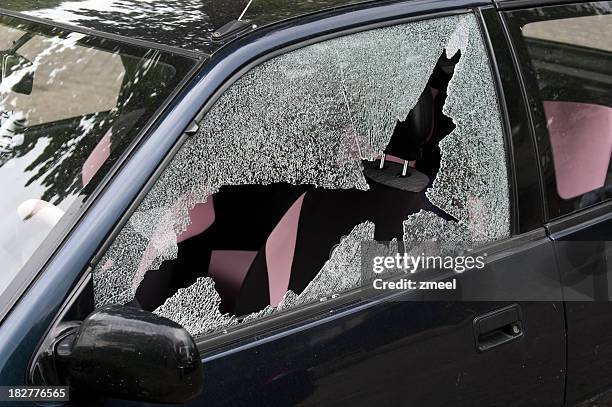 a broken and smashed window of a car in a driveway - broken glass car stock pictures, royalty-free photos & images