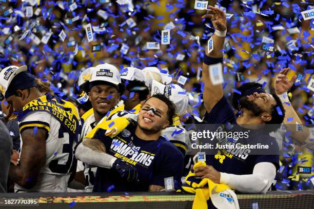 Blake Corum of the Michigan Wolverines celebrates after winning the Big Ten Championship against the Iowa Hawkeyes at Lucas Oil Stadium on December...