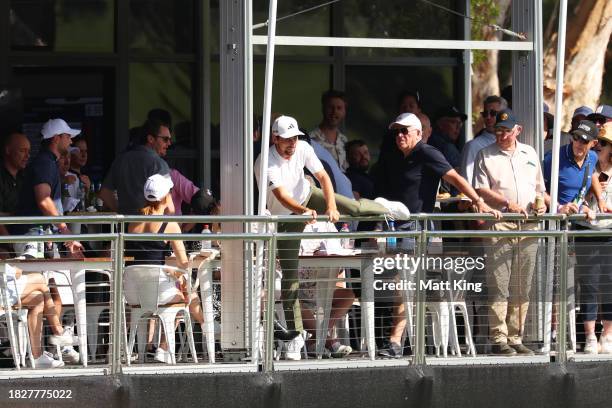 Joaquin Niemann of Chile climbs a fence to enter a hospitality tent to view the green on the 18th hole during the ISPS HANDA Australian Open at The...