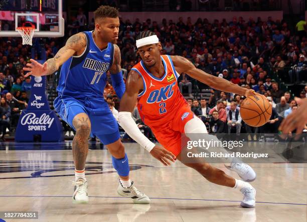 Dexter Dennis of the Dallas Mavericks guards Shai Gilgeous-Alexander of the Oklahoma City Thunder in the first half at American Airlines Center on...