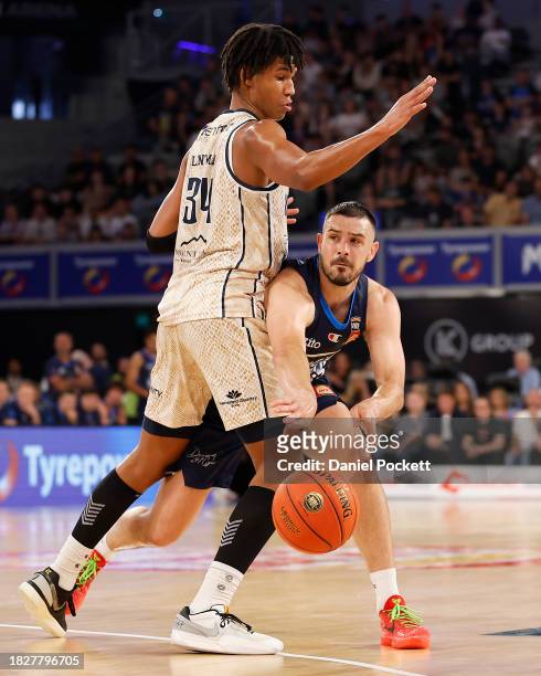 Chris Goulding of United passes the ball under pressure from Bobi Klintman of the Taipans during the round nine NBL match between Melbourne United...