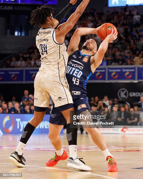 Chris Goulding of United passes the ball under pressure from Bobi Klintman of the Taipans during the round nine NBL match between Melbourne United...