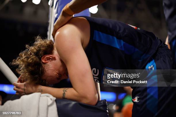 Luke Travers of United reacts after hurting himself in a contest during the round nine NBL match between Melbourne United and Cairns Taipans at John...