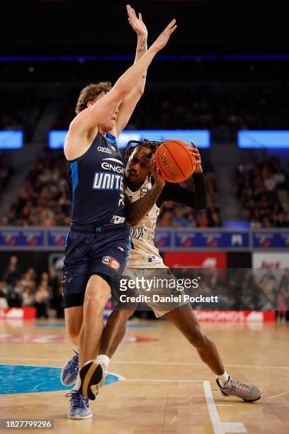 Tahjere McCall of the Taipans drives to the basket under pressure from Luke Travers of United during the round nine NBL match between Melbourne...
