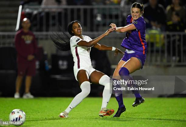 Jordynn Dudley of the Florida State Seminoles and Mackenzie Duff of the Clemson Tigers battle for the ball in the first half during the semifinals...