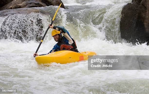 man paddling a white water kayak on an idaho river. - kayaking rapids stock pictures, royalty-free photos & images