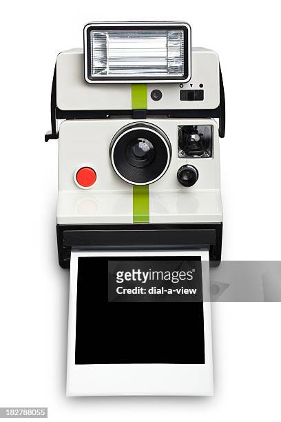 an instant camera with a flash developing film - polaroid stockfoto's en -beelden