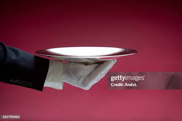 butler holding empty silver tray on red xxl - red glove stock pictures, royalty-free photos & images