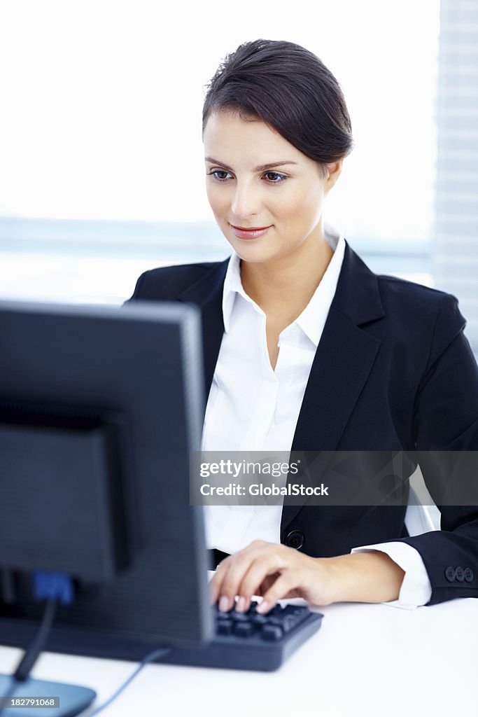 Businesswoman in suit working on computer at office