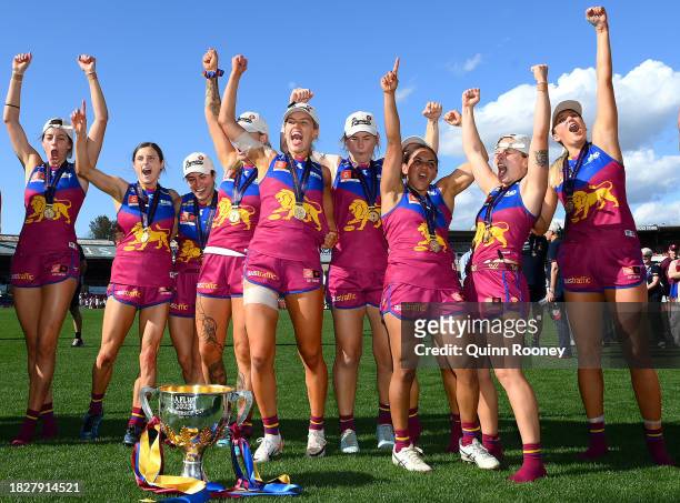 The Lions celebrate with the Premiership Trophy during the AFLW Grand Final match between North Melbourne Tasmania Kangaroos and Brisbane Lions at...
