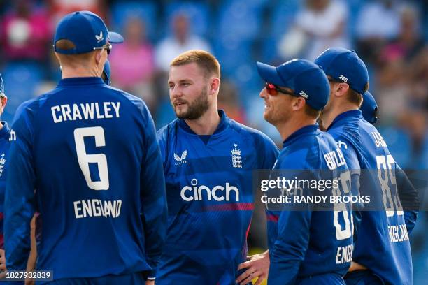 Gus Atkinson and Jos Buttler of England celebrate the dismissal of Alick Athanaze of West Indies during the 2nd ODI match between West Indies and...