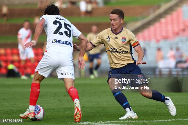 Brandon O’Neill of the Jets and Callum Talbot of Melbourne City challenge for the ball during the A-League Men round six match between Newcastle Jets...